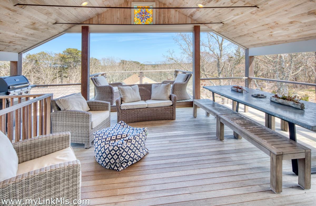 72 Chappaquiddick Avenue Edgartown, MA 02539 - Photo 44 of 63 Open, airy, guest house porch with water views beyond!