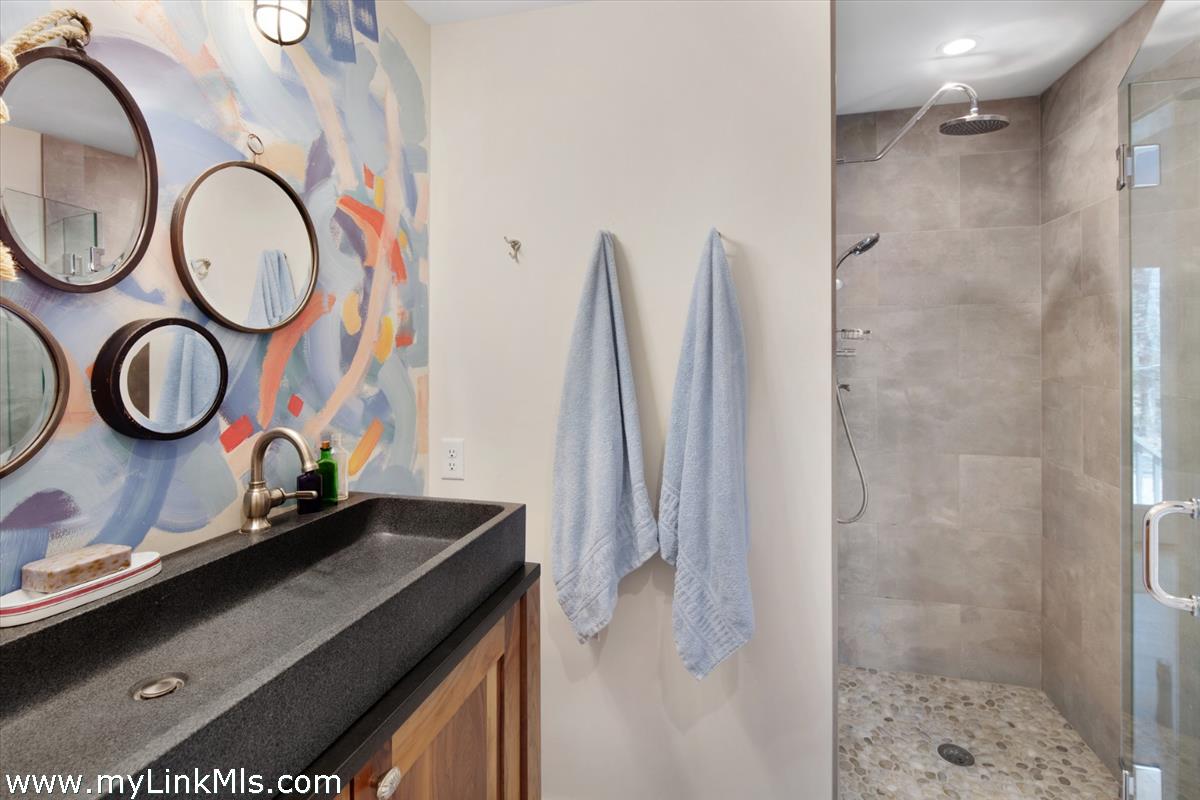 72 Chappaquiddick Avenue Edgartown, MA 02539 - Photo 49 of 63 a bathroom with a sink and a mirror