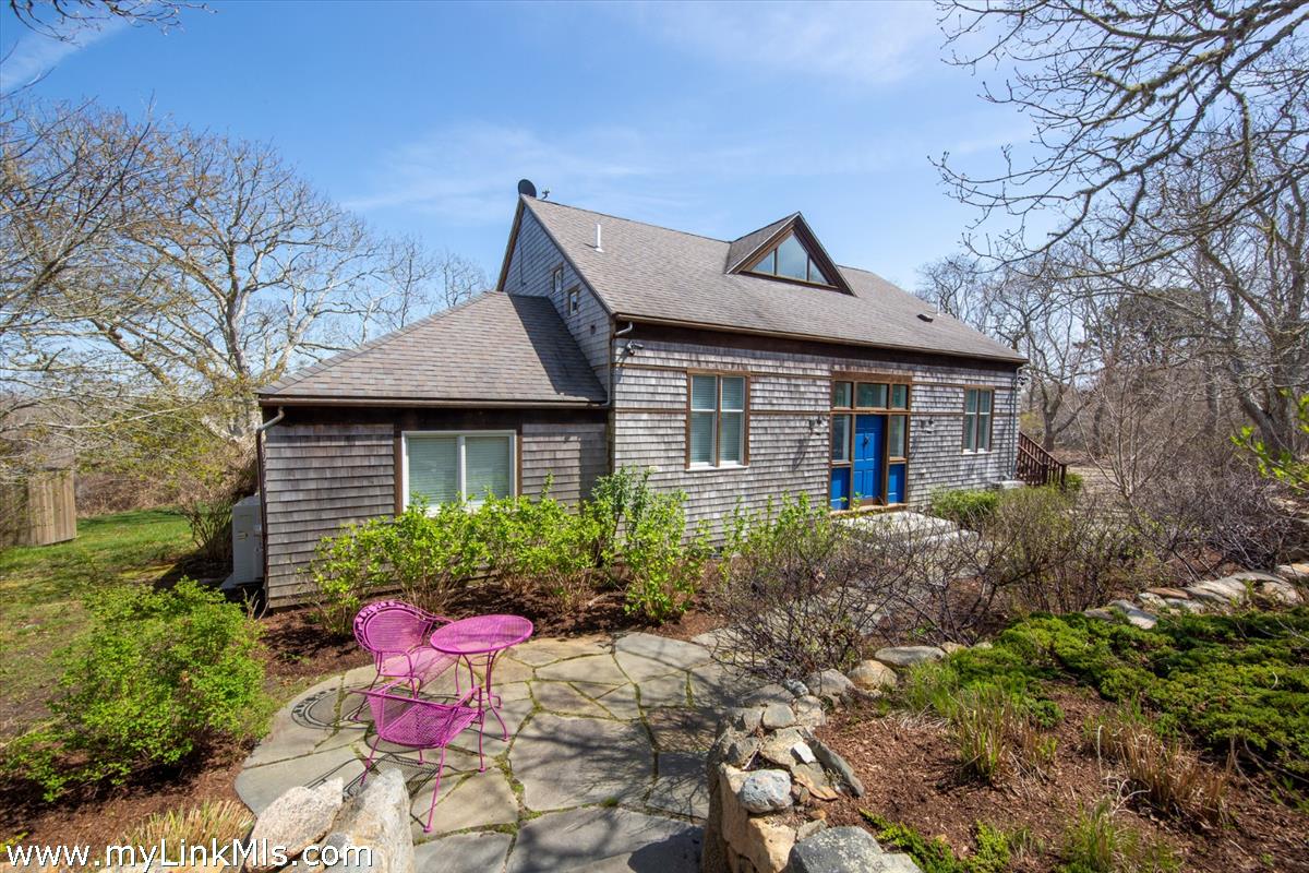72 Chappaquiddick Avenue Edgartown, MA 02539 - Photo 6 of 63 a front view of a house with a yard