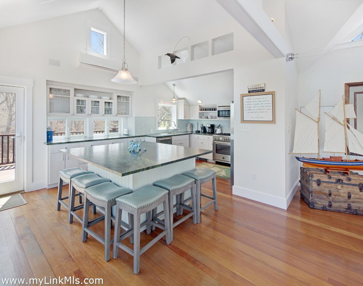 72 Chappaquiddick Avenue Edgartown, MA 02539 - Photo 10 of 63 a living room with stainless steel appliances kitchen island granite countertop furniture and a wooden floor