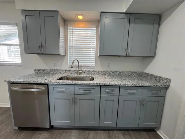 a kitchen with cabinets appliances and a sink