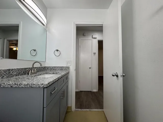 a view of a hallway with wooden floor and closet