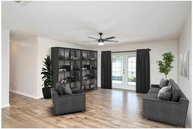 a living room with furniture and wooden floor