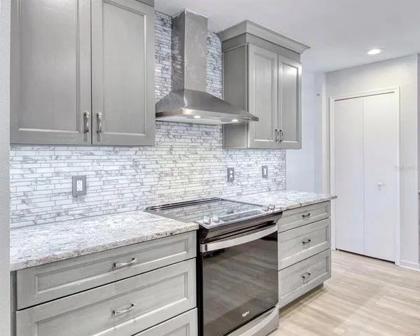 a kitchen with granite countertop a sink cabinets and window