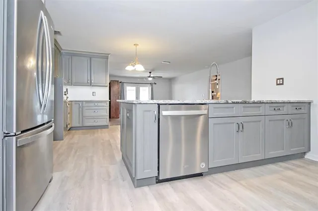 a kitchen with stainless steel appliances a refrigerator sink and cabinets