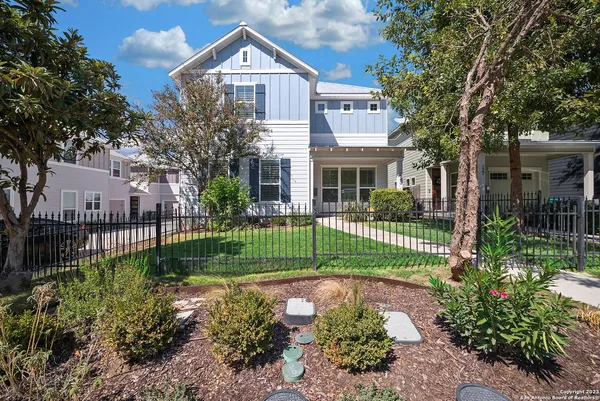 a front view of a house with a garden and plants