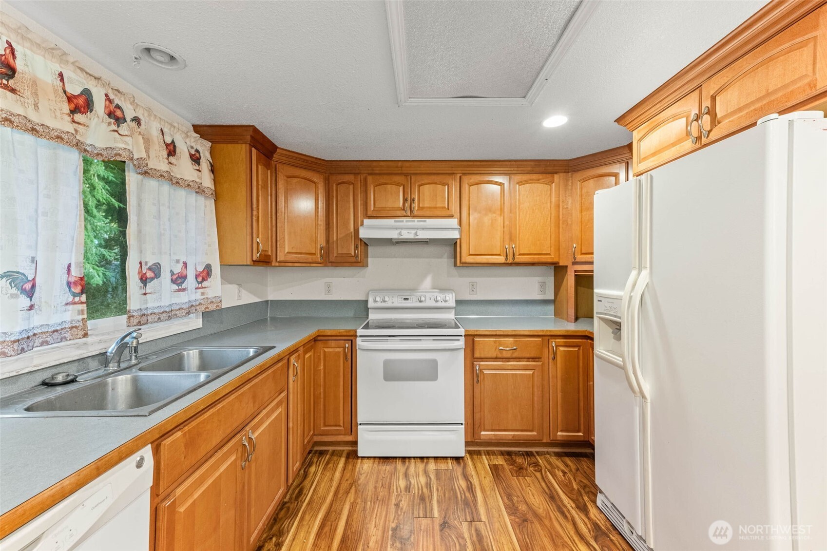 8529 37th Court Southeast Lacey, WA 98503 - Photo 11 of 34 a kitchen with stainless steel appliances granite countertop a sink a stove and refrigerator