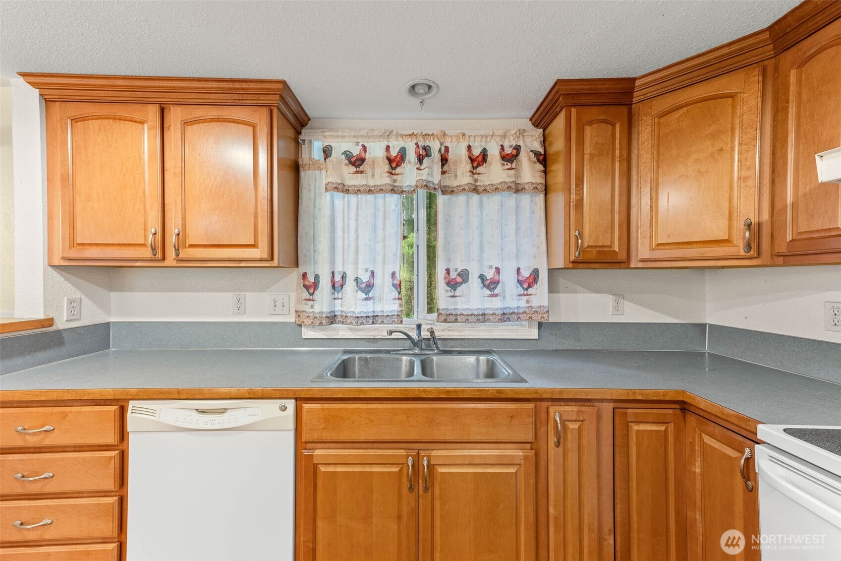 8529 37th Court Southeast Lacey, WA 98503 - Photo 13 of 34 a kitchen with stainless steel appliances granite countertop a sink and a window