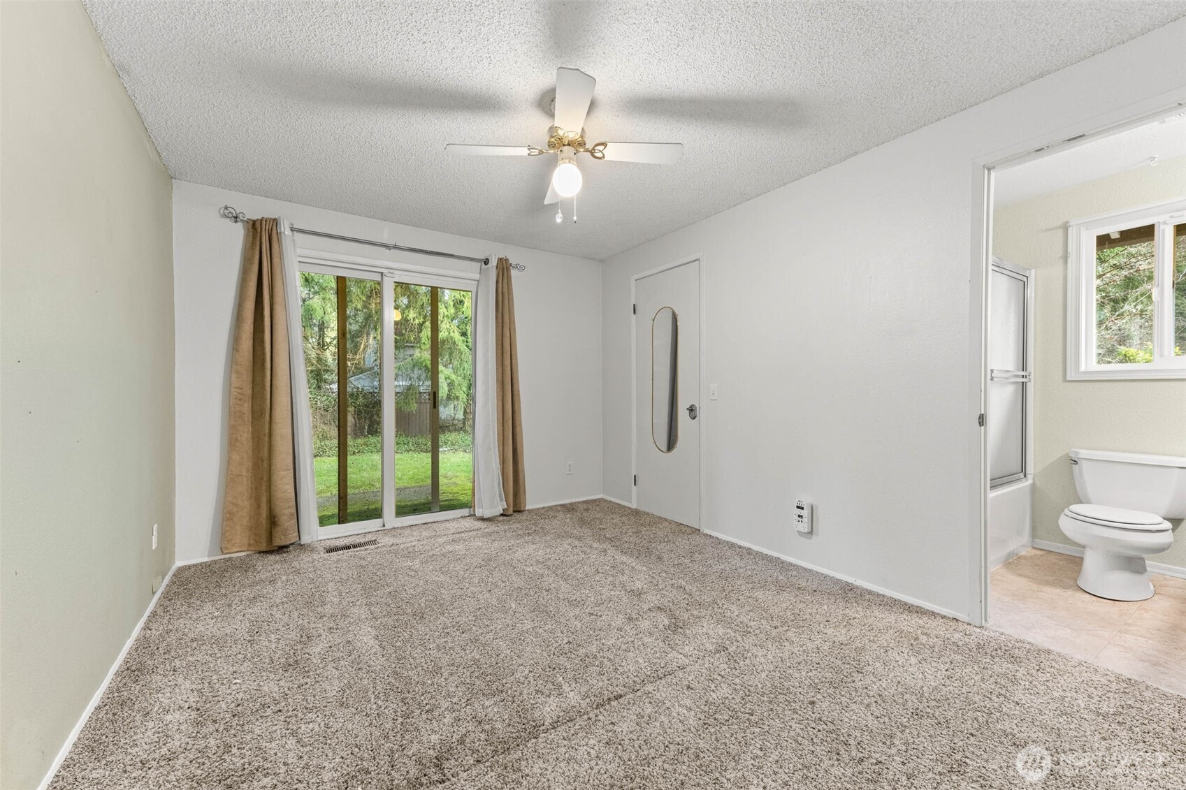 8529 37th Court Southeast Lacey, WA 98503 - Photo 18 of 34 a view of a big room with windows and chandelier fan