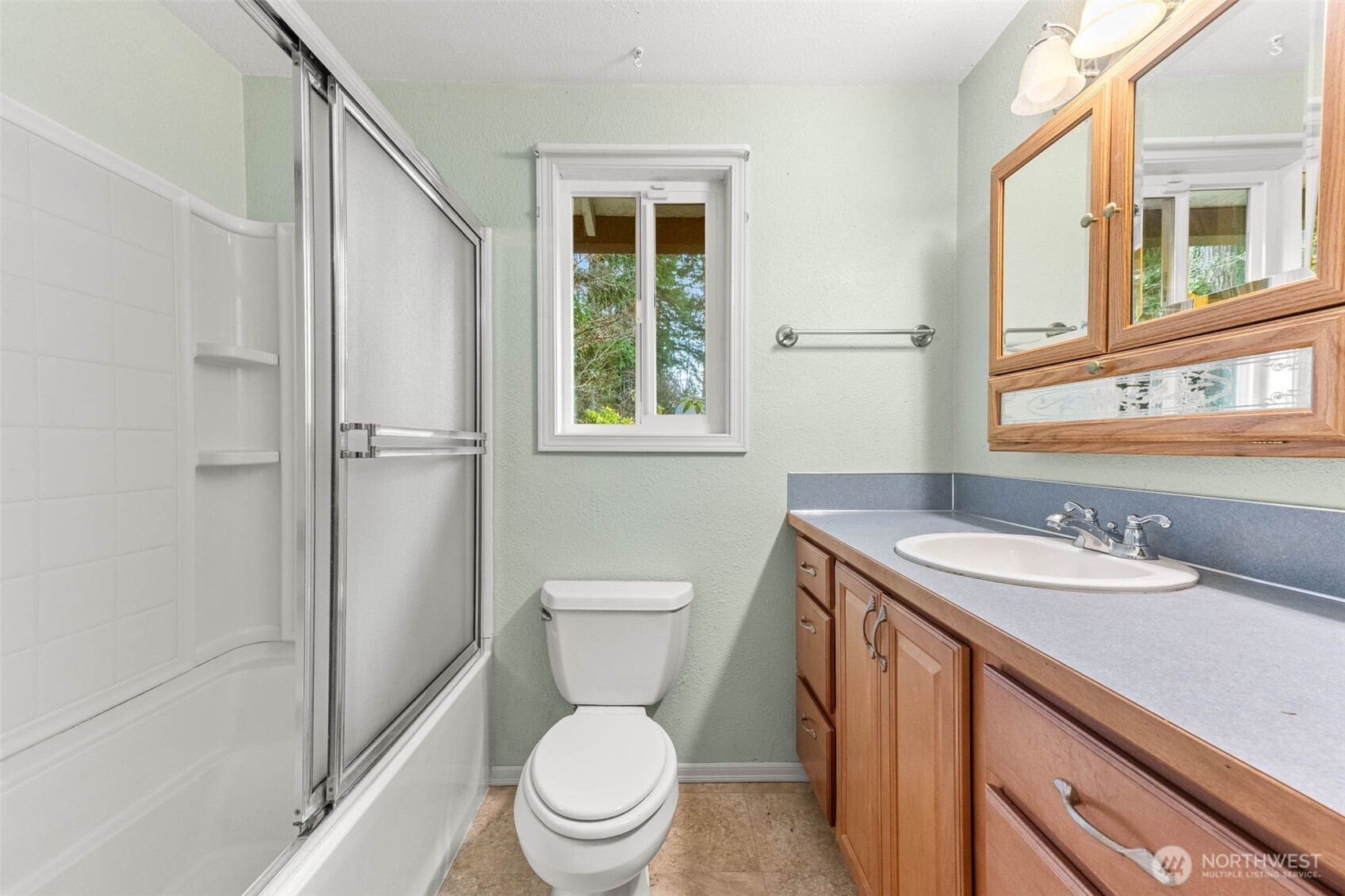 8529 37th Court Southeast Lacey, WA 98503 - Photo 21 of 34 a bathroom with a granite countertop toilet sink and a shower