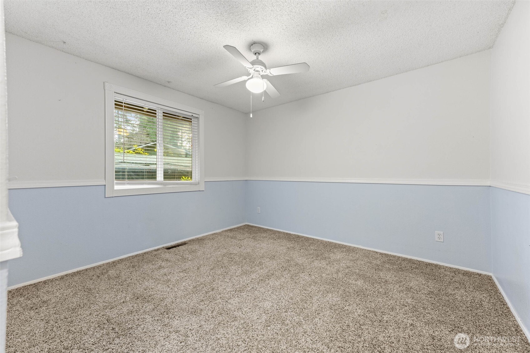8529 37th Court Southeast Lacey, WA 98503 - Photo 22 of 34 an empty room with a window and a ceiling fan