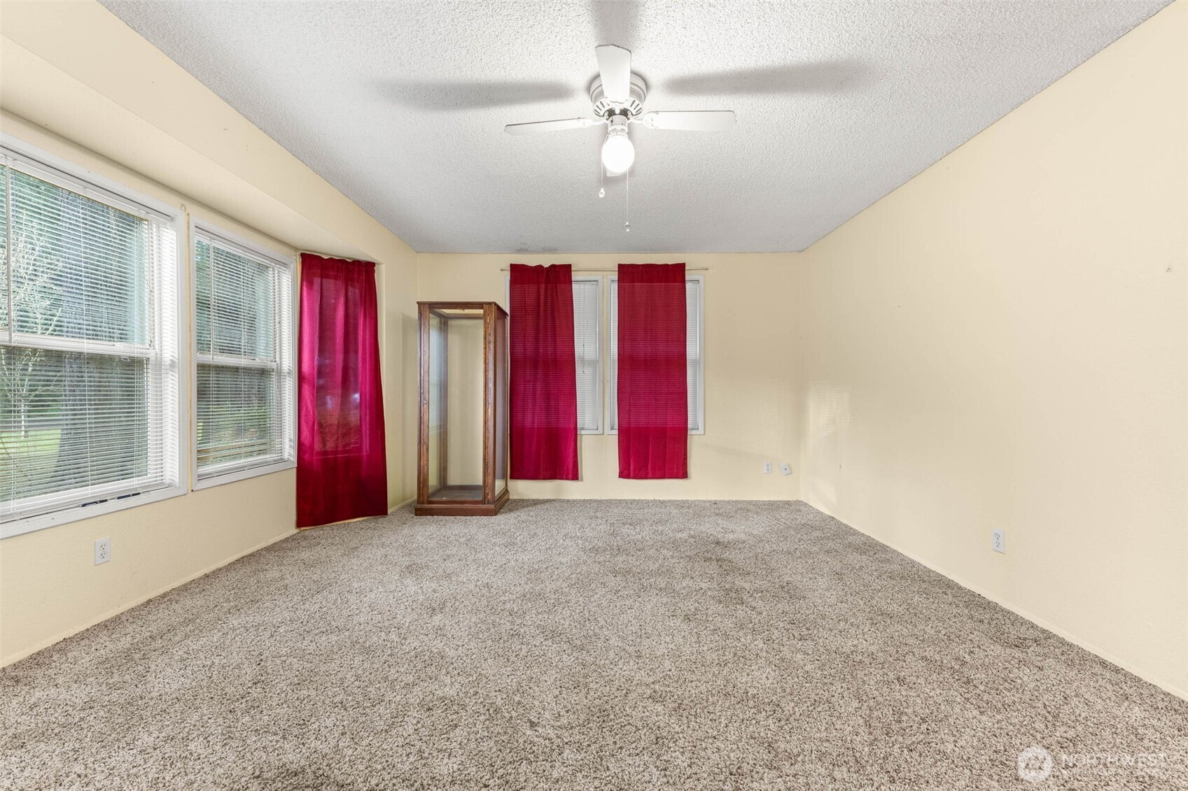 8529 37th Court Southeast Lacey, WA 98503 - Photo 4 of 34 an empty room with windows and chandelier fan