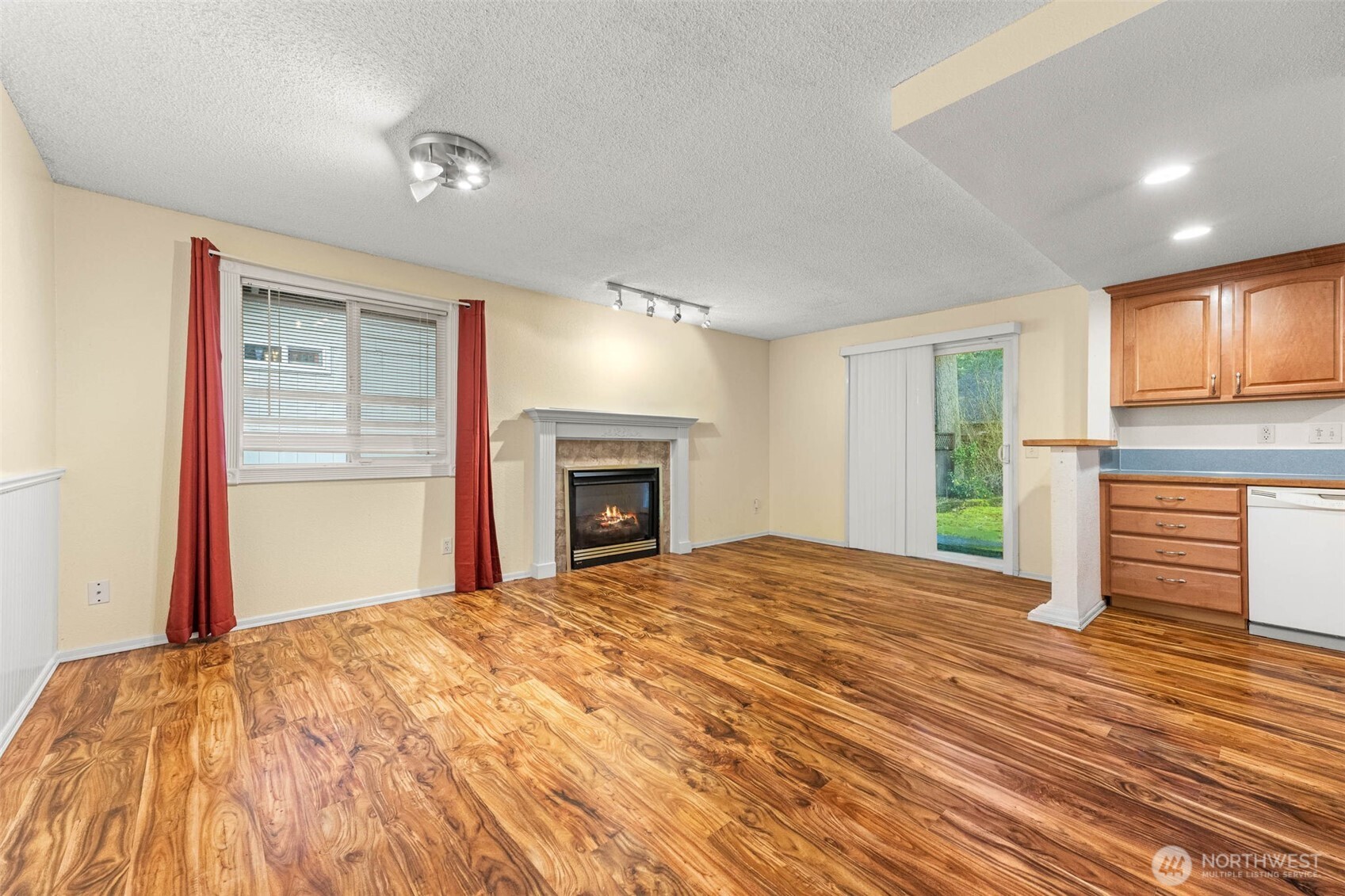 8529 37th Court Southeast Lacey, WA 98503 - Photo 6 of 34 a view of empty room with wooden floor and fireplace