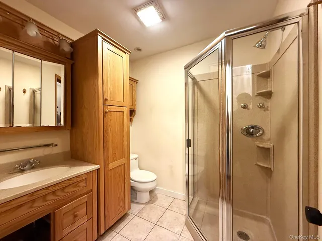 a spacious bathroom with a granite countertop sink toilet and shower