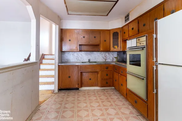a kitchen with granite countertop cabinets and refrigerator