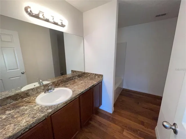 a bathroom with sink granite and mirror