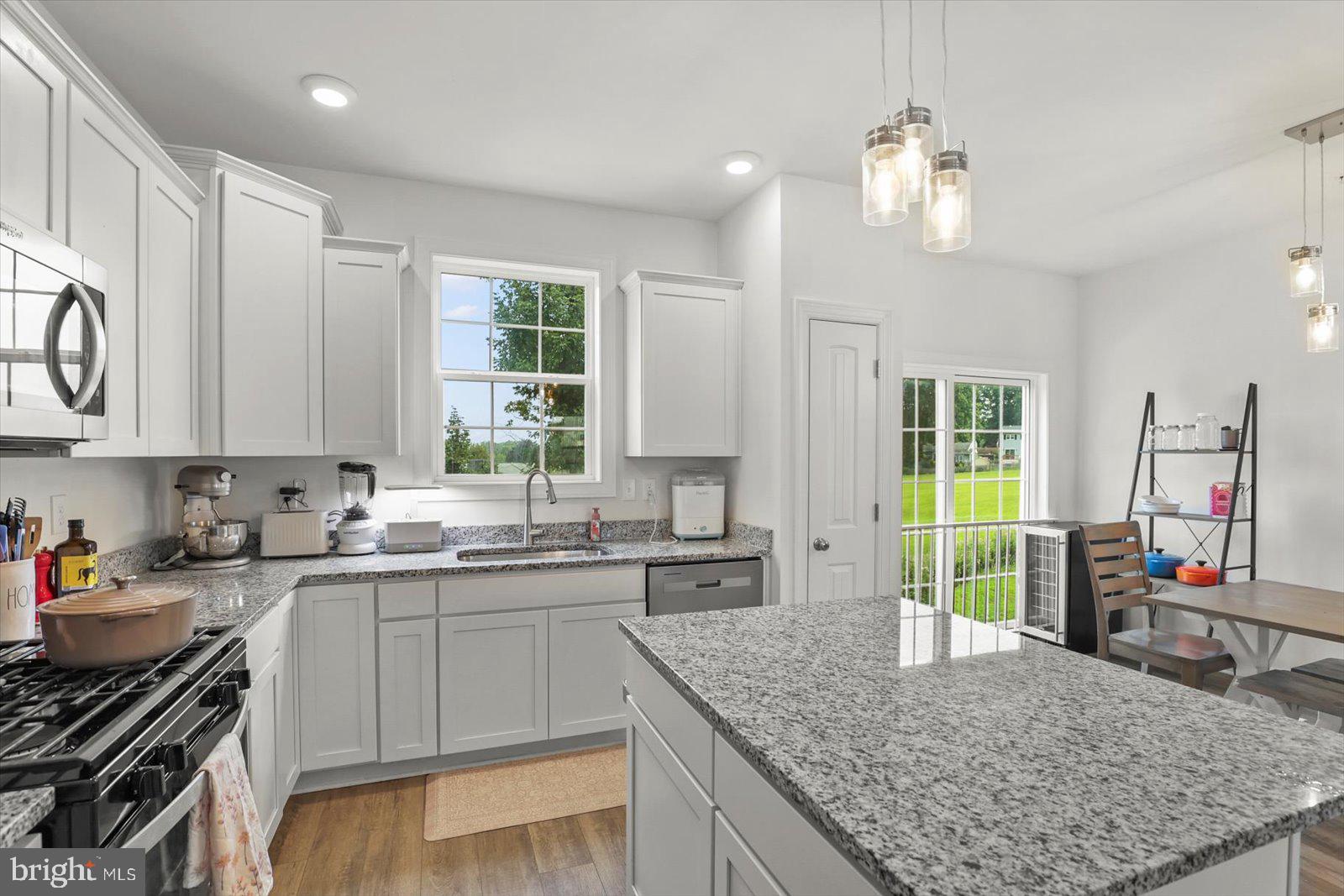 103 Overlook Dr. Hanover, PA 17331 - Photo 12 of 39 a kitchen with stainless steel appliances granite countertop a sink stove and cabinets