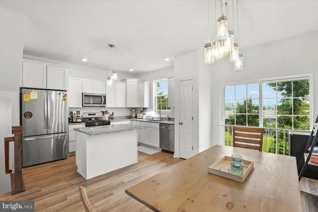 a living room with furniture and a dining table