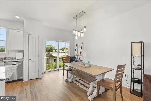 a view of a dining room with furniture wooden floor and chandelier