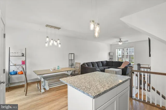 a living room with furniture and kitchen view