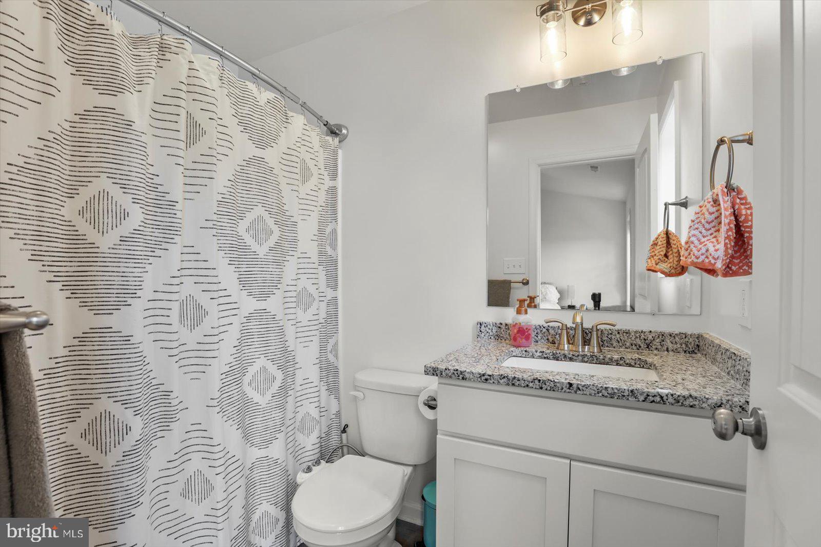 103 Overlook Dr. Hanover, PA 17331 - Photo 23 of 39 a bathroom with a granite countertop sink mirror vanity and toilet