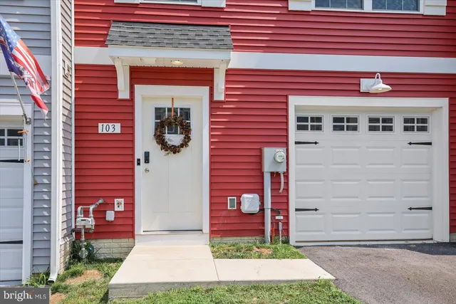 a front view of a residential apartment building with a yard
