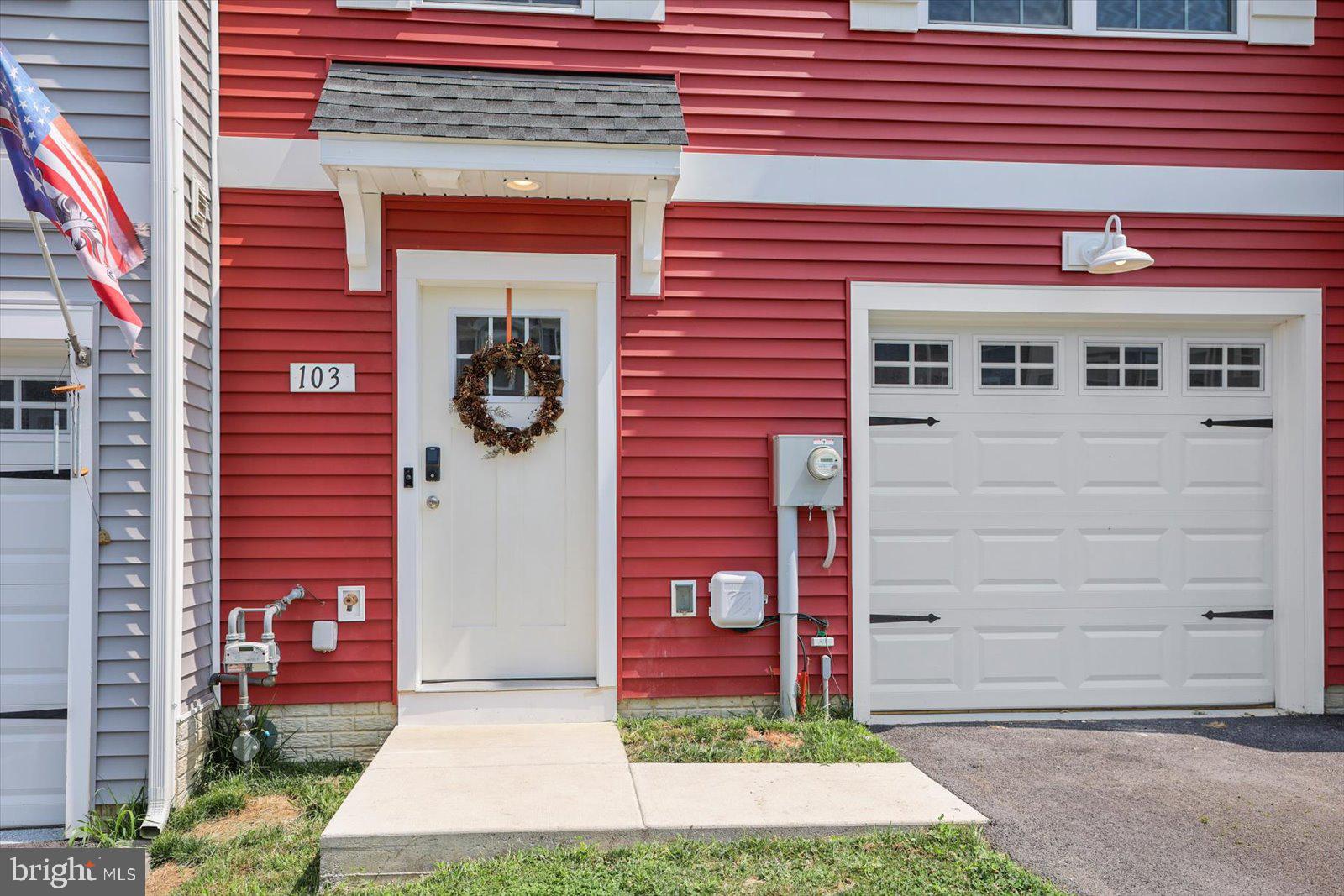103 Overlook Dr. Hanover, PA 17331 - Photo 3 of 39 a front view of a building with a garden and plants