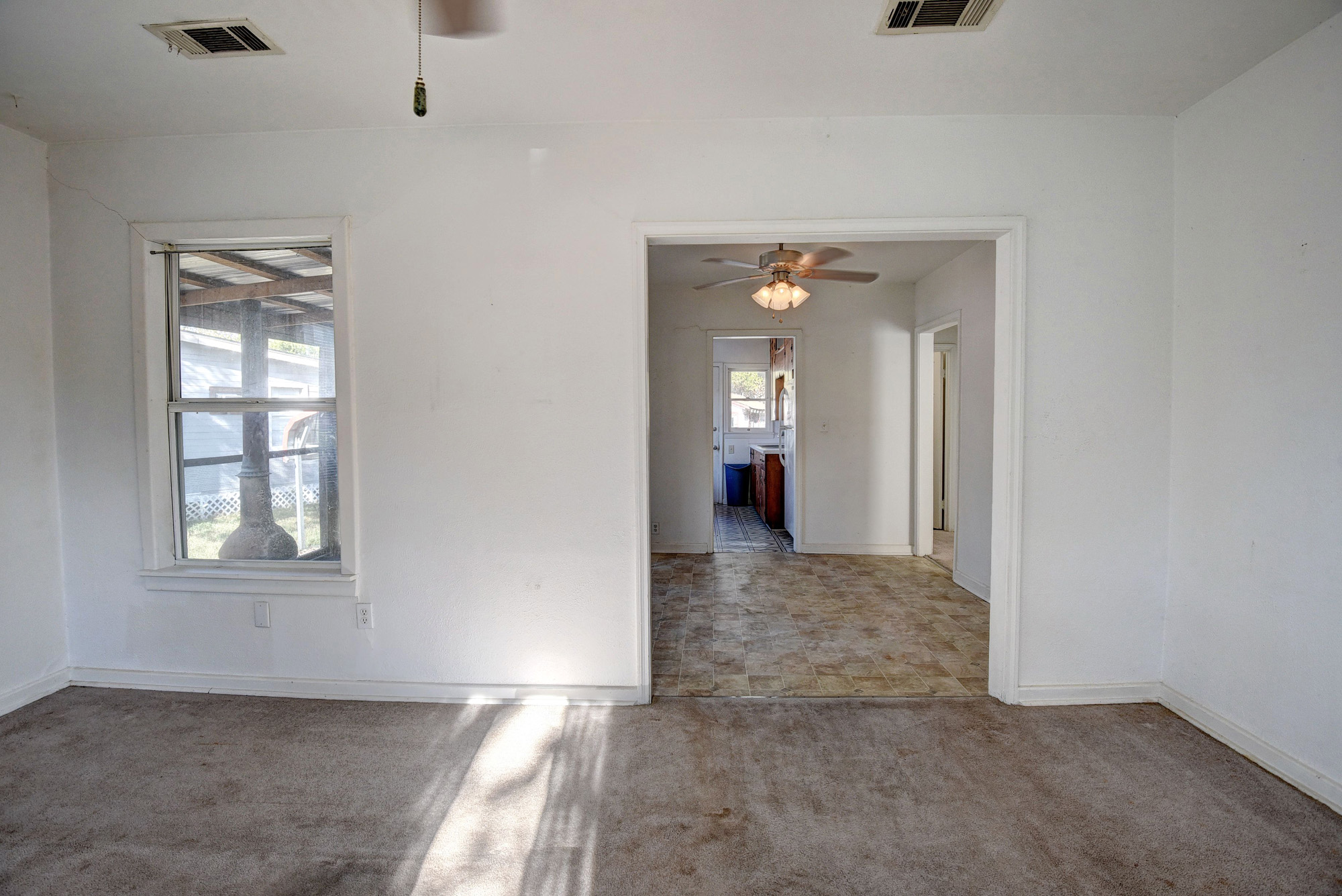 304 Cedar Street Bastrop, TX 78602 - Photo 11 of 33 an empty room with windows and cabinet