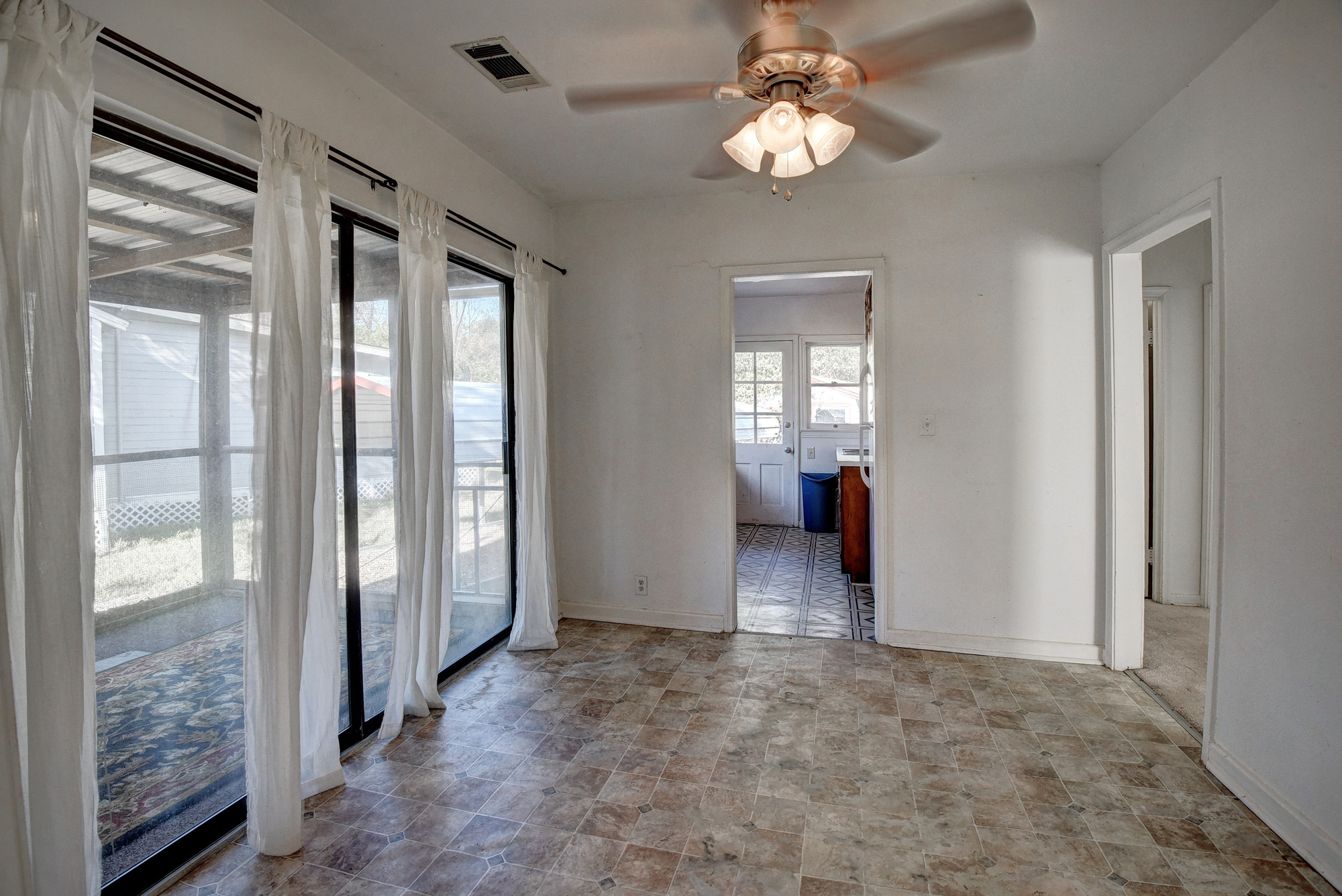 304 Cedar Street Bastrop, TX 78602 - Photo 12 of 33 a view of a livingroom with wooden floor and a ceiling fan