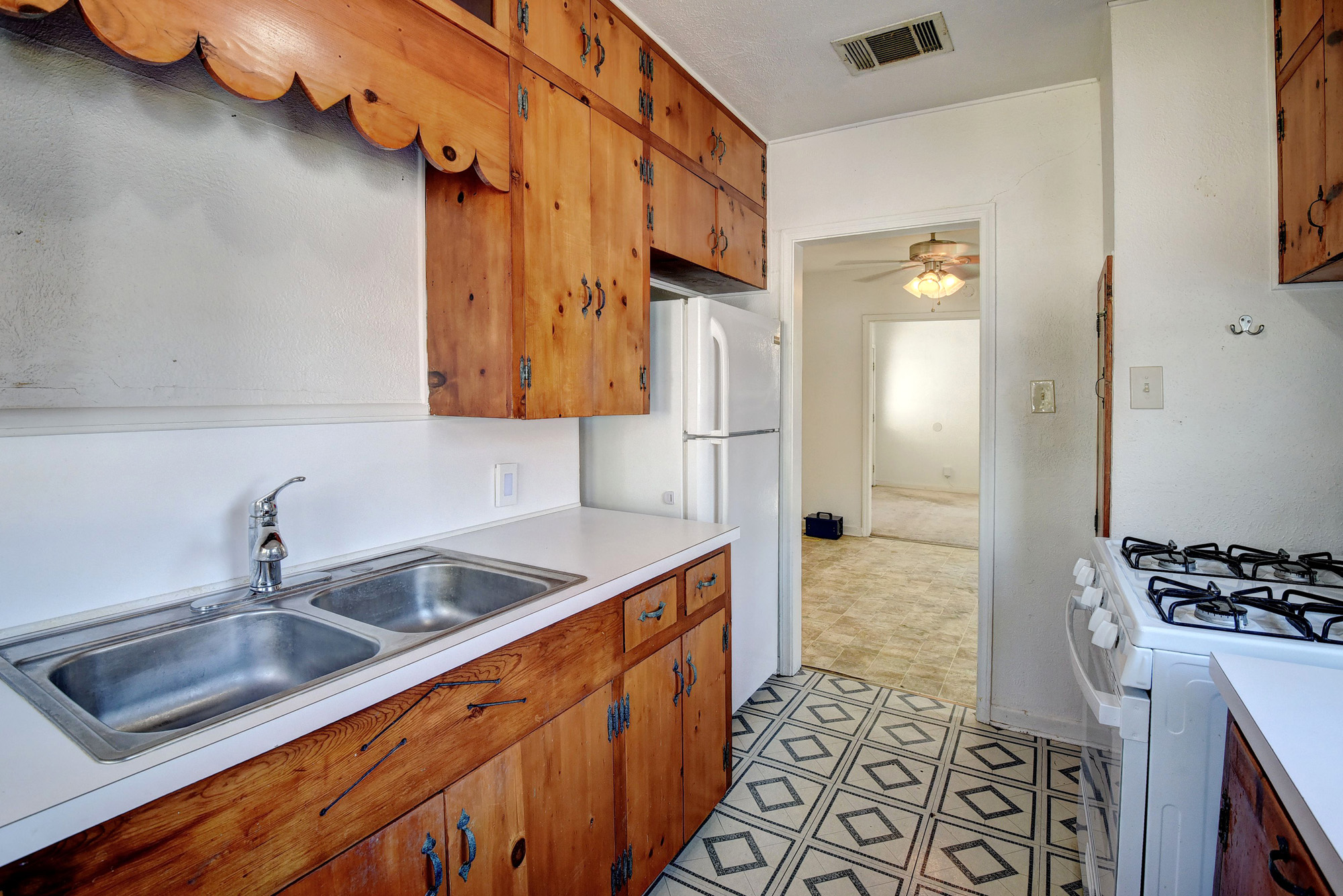 304 Cedar Street Bastrop, TX 78602 - Photo 18 of 33 a kitchen with stainless steel appliances granite countertop a sink stove and refrigerator