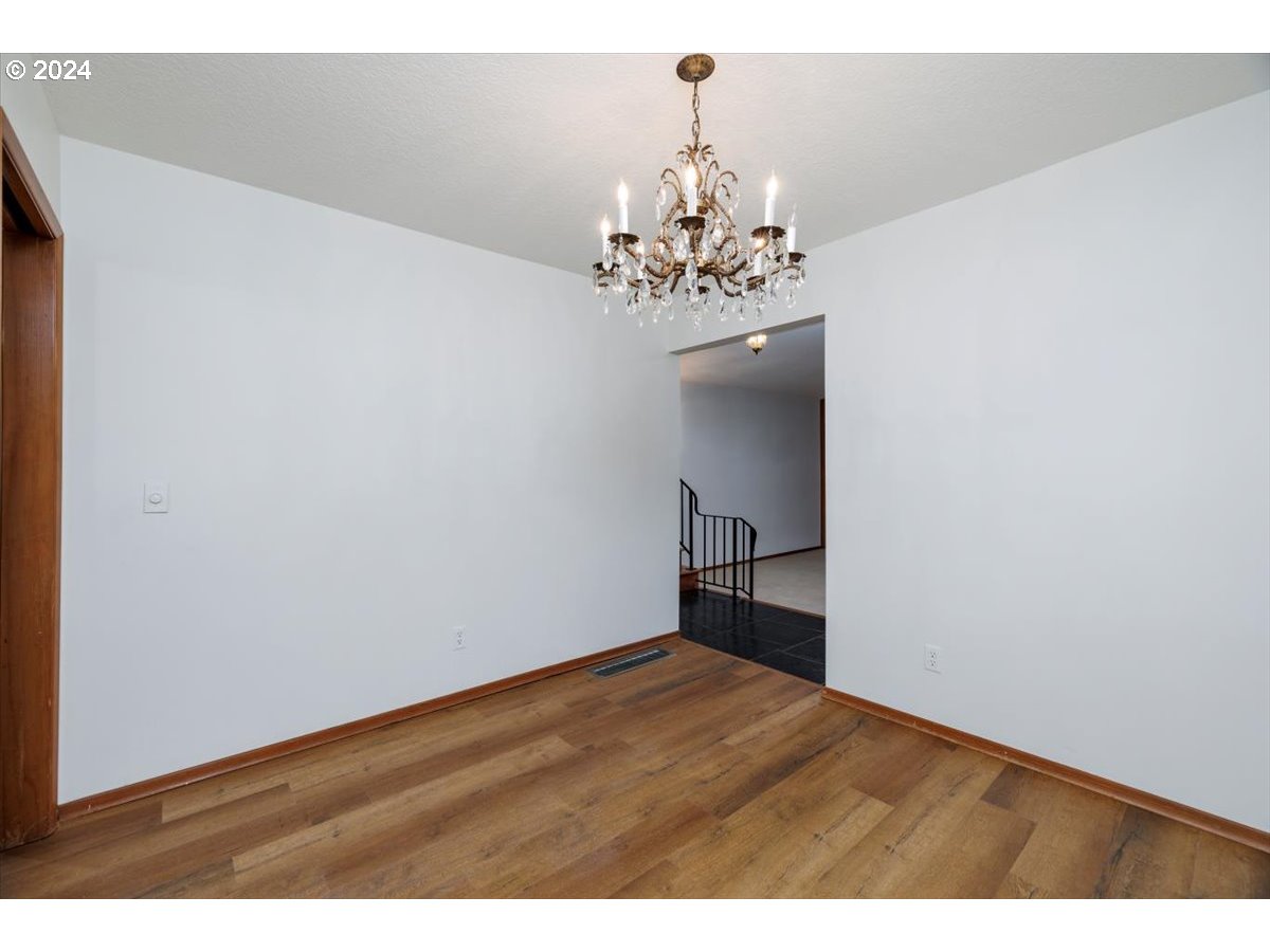 13400 Northwest Northrup Street Portland, OR 97229 - Photo 11 of 39 a view of a big room with wooden floor and chandelier