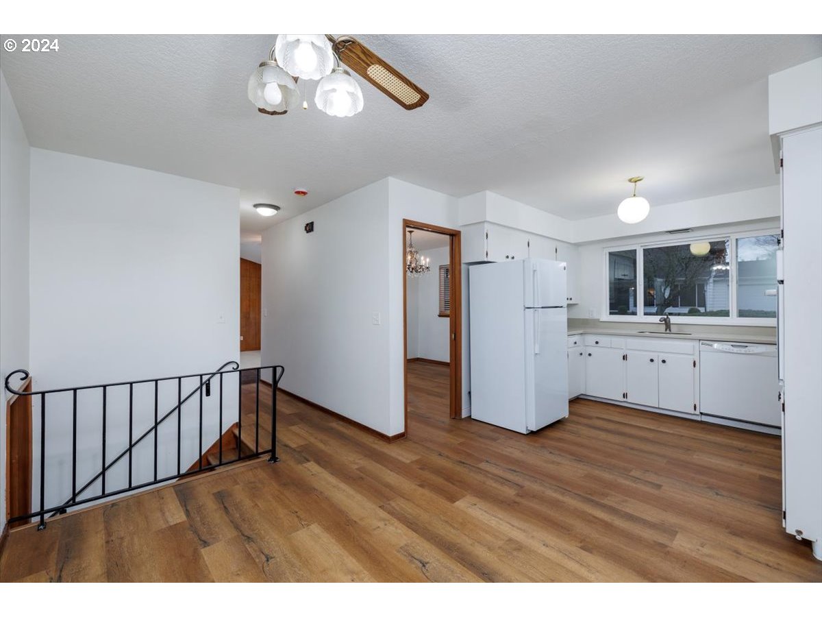 13400 Northwest Northrup Street Portland, OR 97229 - Photo 12 of 39 a view of an empty room with wooden floor and a window