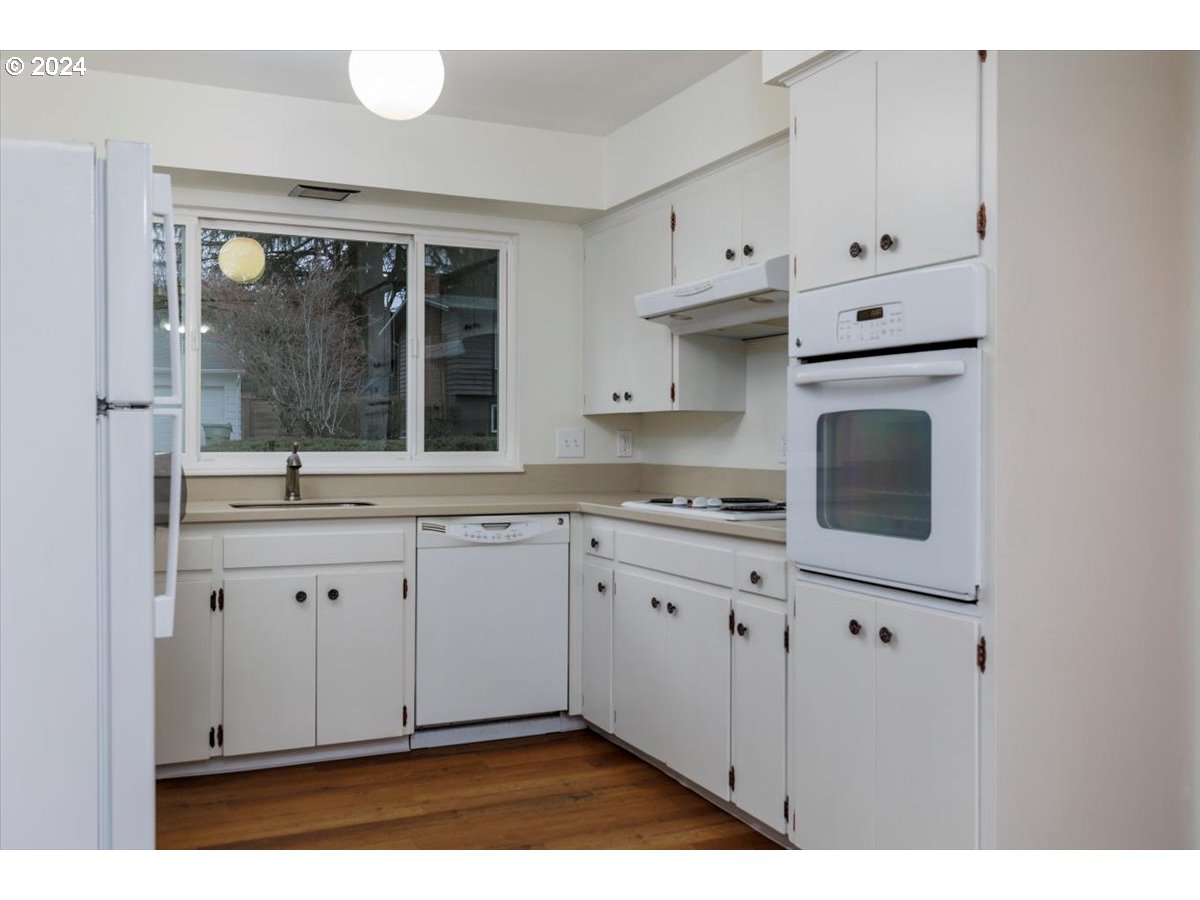 13400 Northwest Northrup Street Portland, OR 97229 - Photo 14 of 39 a kitchen with granite countertop cabinets stainless steel appliances a sink and a window
