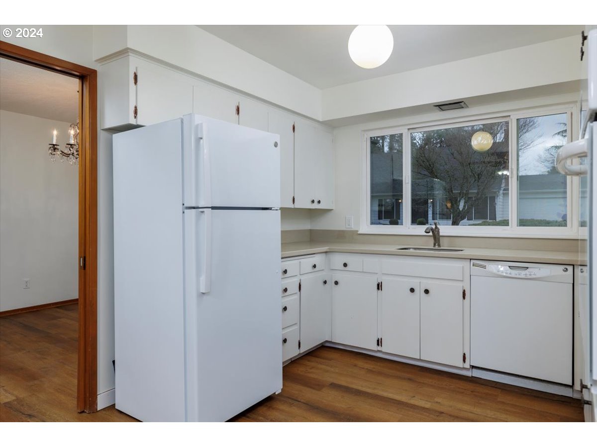 13400 Northwest Northrup Street Portland, OR 97229 - Photo 15 of 39 a kitchen with granite countertop white cabinets and refrigerator