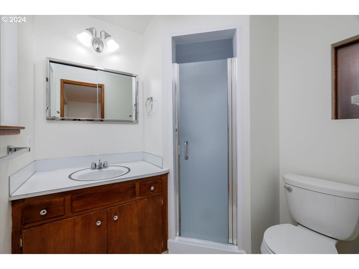 13400 Northwest Northrup Street Portland, OR 97229 - Photo 19 of 39 a bathroom with a toilet sink and mirror