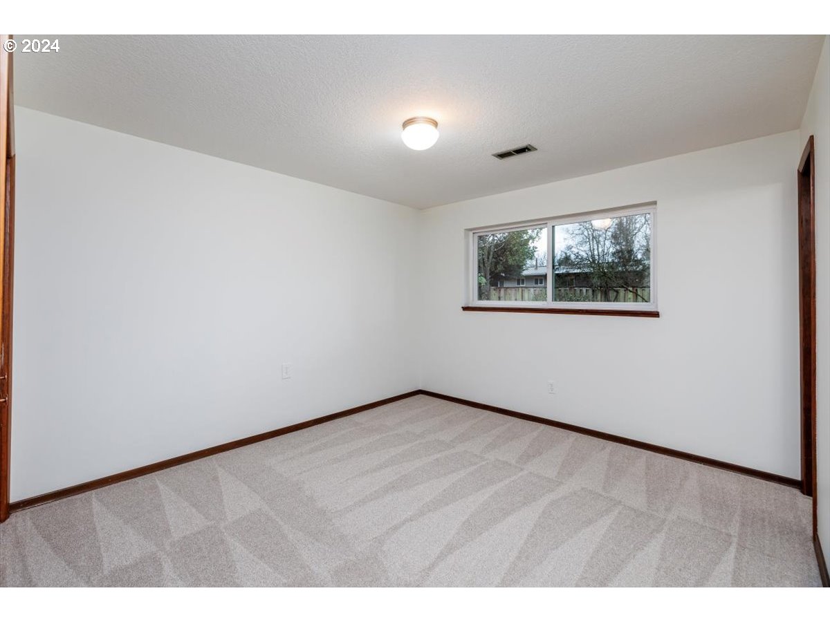 13400 Northwest Northrup Street Portland, OR 97229 - Photo 28 of 39 a view of an empty room with wooden floor and a window