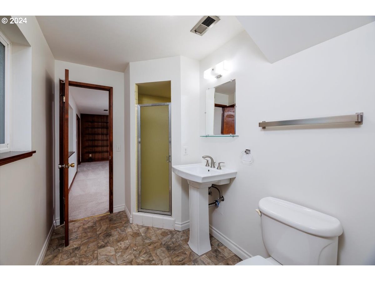 13400 Northwest Northrup Street Portland, OR 97229 - Photo 30 of 39 a bathroom with a sink a toilet and mirror