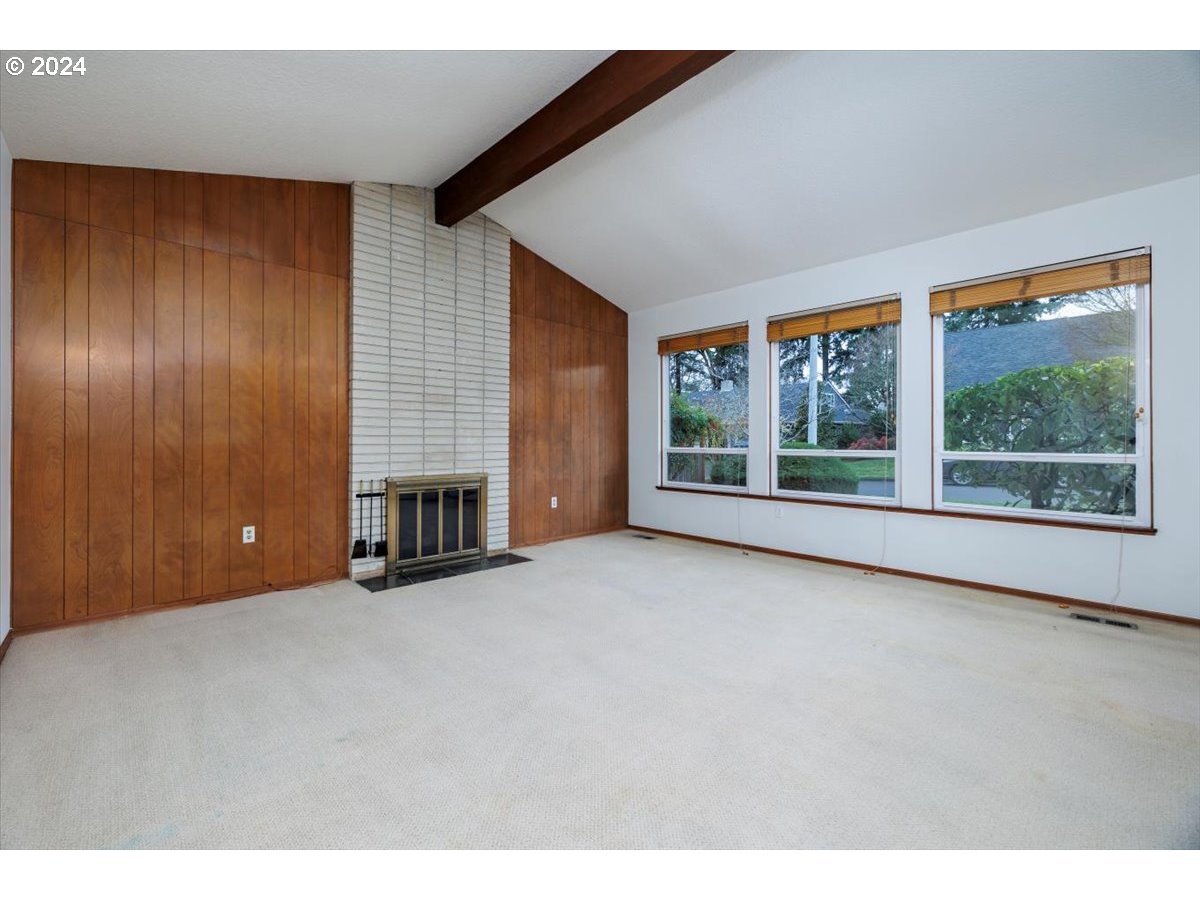 13400 Northwest Northrup Street Portland, OR 97229 - Photo 7 of 39 a view of an empty room with a fireplace and a window