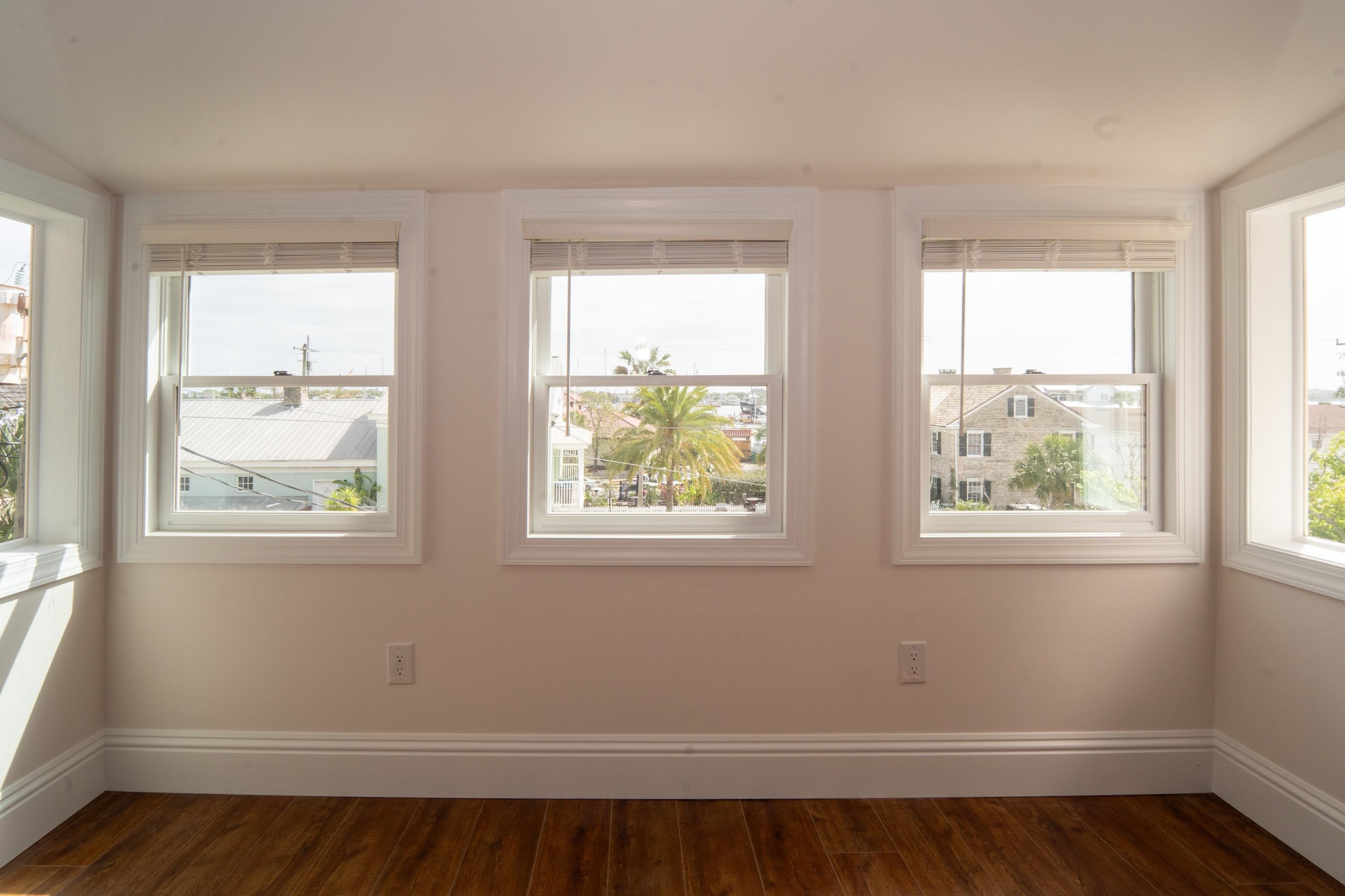 11 Aviles Street St. Augustine, FL 32084 - Photo 15 of 40 a view of an empty room with wooden floor and a window