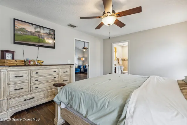 a bedroom with a bed a window and a dresser