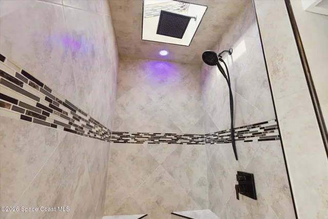 a bathroom with a shower and a window