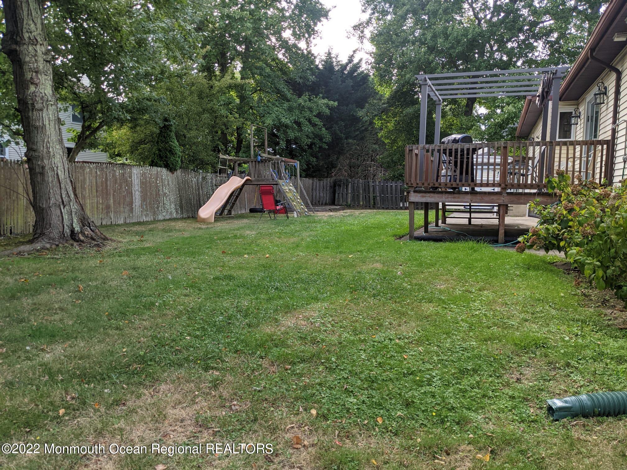 a view of backyard with deck and garden