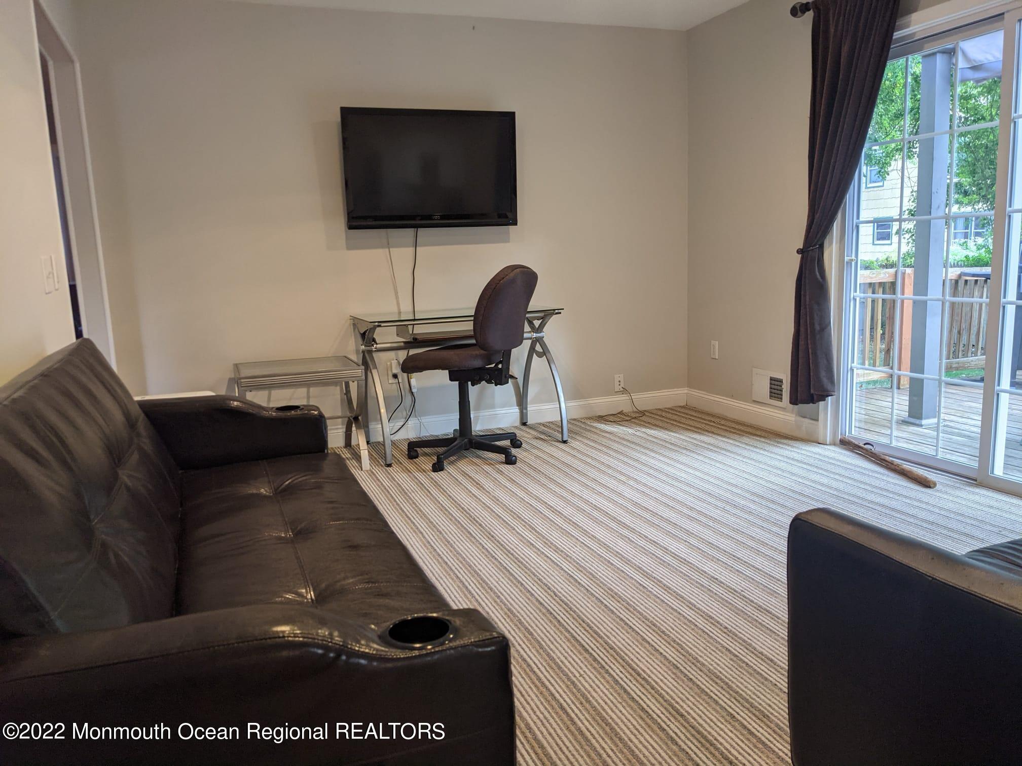 1304 Franklin Avenue Asbury Park, NJ 07712 - Photo 11 of 25 a living room with furniture and a flat screen tv