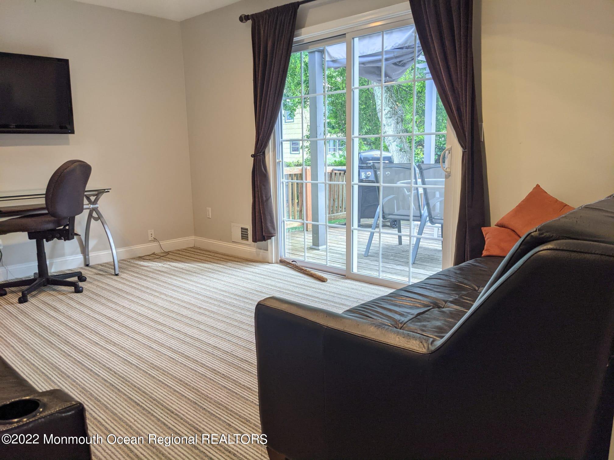1304 Franklin Avenue Asbury Park, NJ 07712 - Photo 12 of 25 a living room with furniture and a flat screen tv