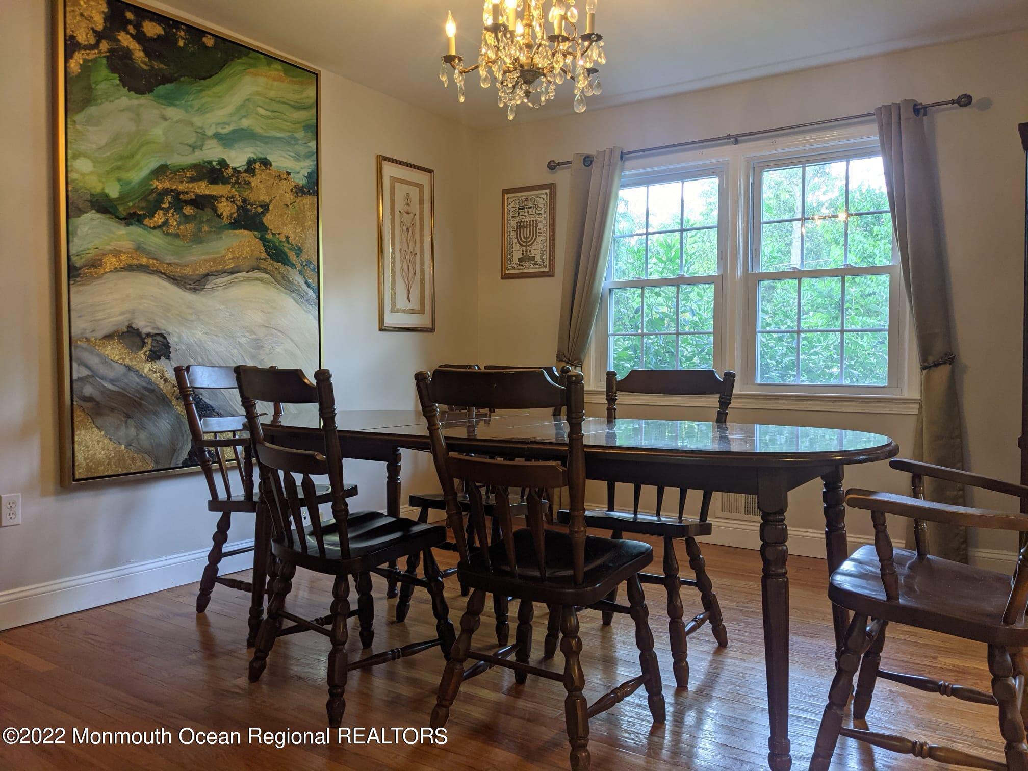 1304 Franklin Avenue Asbury Park, NJ 07712 - Photo 13 of 25 a view of a dining room with furniture a chandelier and wooden floor
