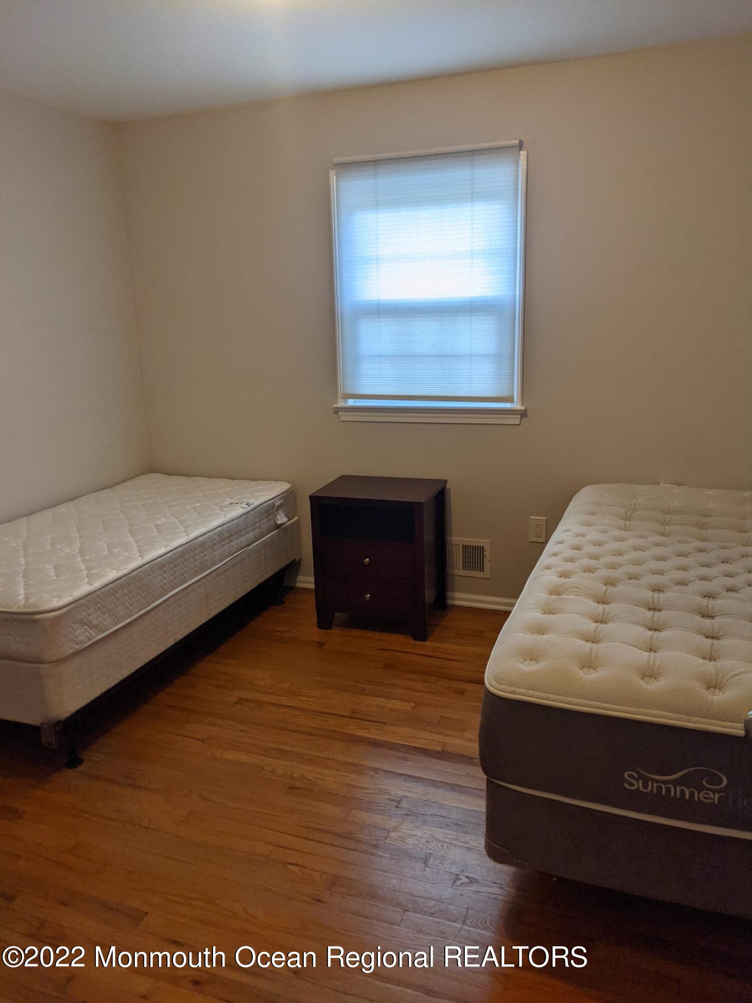 1304 Franklin Avenue Asbury Park, NJ 07712 - Photo 19 of 25 a bedroom with a bed and a night stand