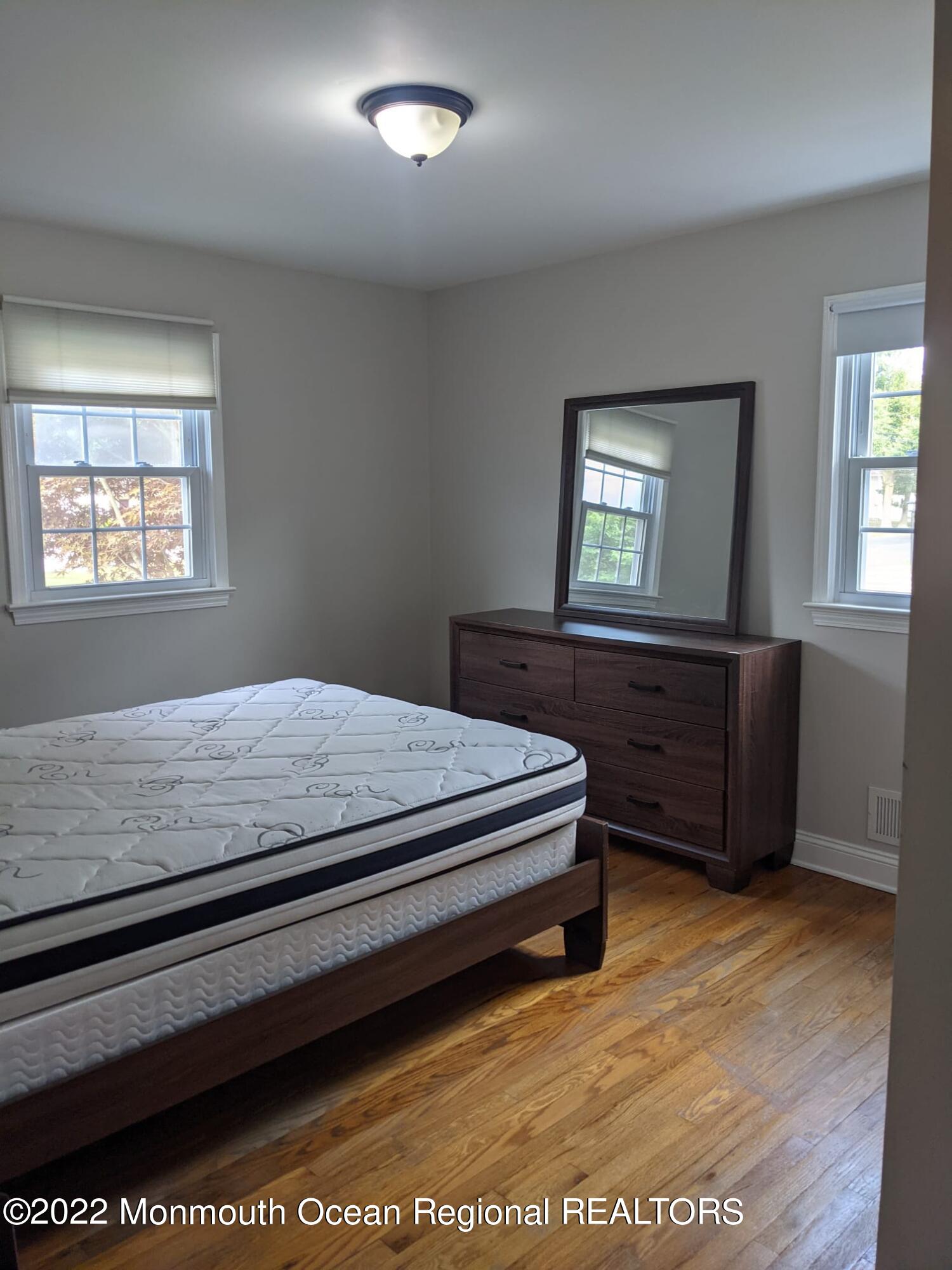 1304 Franklin Avenue Asbury Park, NJ 07712 - Photo 21 of 25 a bedroom with a bed and window