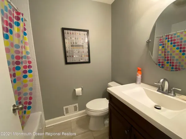a bathroom with a sink mirror vanity and toilet