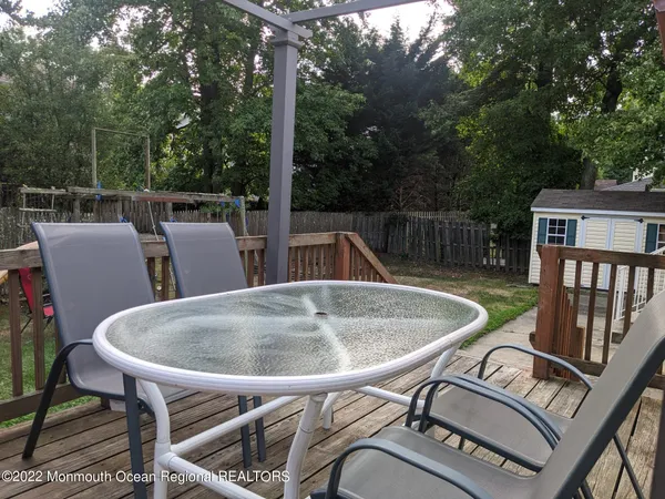 a balcony with table and chairs