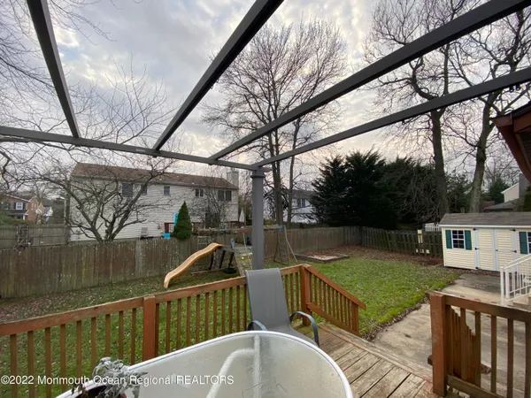 a view of a couches with wooden floor in front of house
